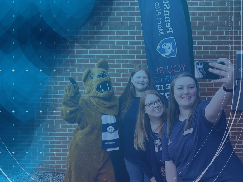 STUDENTS TAKING A SELFIE WITH THE MASCOT
